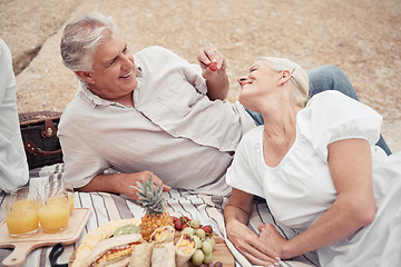 Image showing Food, beach and picnic senior couple dating or on romantic honeymoon date with fruit, snack and drink. Happy, love and romance woman and man or elderly people eating and feed together for anniversary