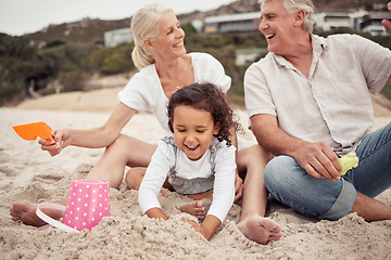 Image showing Family, beach and a girl and her grandparents playing in the sand outside during summer. Kids, love and vacation with a man and woman and granddaughter laughing and bonding outdoor