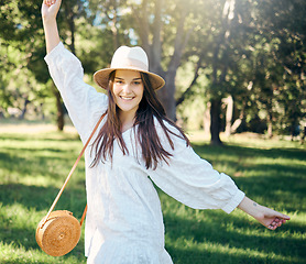 Image showing Happy woman in nature park dancing in summer with freedom, sunlight and natural fresh air in portrait. Dance, happiness and young girl with smile in casual dress having outdoor fun on spring holiday