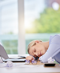 Image showing Sleep, burnout and tired with a business woman sleeping at her desk in the office at work. Mental health, overworked and overtime with a mature female employee lying on her desk with her eyes closed