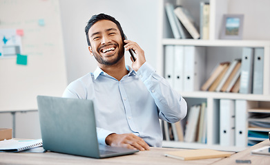 Image showing Happy businessman on a phone call while working on a laptop at the desk in his modern office. Corporate, professional and company manager laughing while having a mobile conversation with technology.