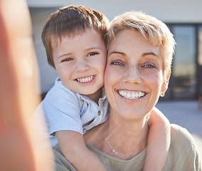 Image showing Selfie, grandma and child love to smile, play and bond together outdoor at family home or house. Happy senior, elderly or grandparent with young kid smiling for joy, happiness and care outside