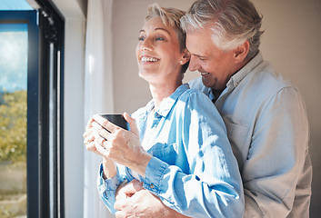 Image showing Love, senior couple and retirement vacation while sharing a hug, drinking coffee and looking out window at home or in a hotel. Happy mature man and woman sharing a special bond and laughing together