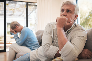 Image showing Elderly couple stress after conflict, sad news or fight in living room of their home. Senior man with woman in retirement on sofa with expression of disappointment, angry or depressed in house