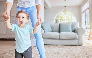 Image showing Mother helping baby walk his first steps in living room for child development, growth and physical progress with lens flare. Young excited kid learning, walking with love and support from mom at home