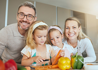 Image showing Mom, dad and children in the kitchen, cooking together and learning. Portrait of family at home teaching kids how to cook, cut vegetables and prepare food. Child development, educate and life skills