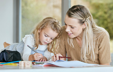 Image showing Mother help youth girl with school work, homework or preschool education while writing in notebook. Mom helping, teaching or tutor daughter, student or young learning kid in math, history or english