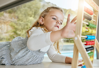 Image showing Education, learning and girl counting and practice math in homeschool activity. Child development, abacus and distance learning with child playing and relaxing in a living room, being playful alone