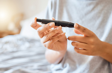 Image showing Healthcare, diabetes, and a woman using blood sugar test on finger in bedroom alone. Health, innovation and the daily life of a diabetic lady on bed with glucometer to check glucose level at home.