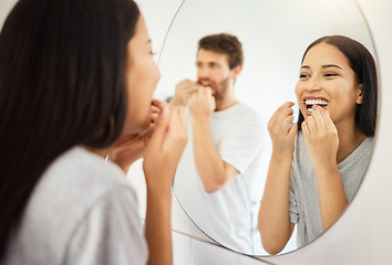 Image showing Mirror, dental floss and teeth healthcare couple cleaning mouth for healthy gums, smile and fresh breath. Man and woman in bathroom flossing morning during routine for dental hygiene in the morning