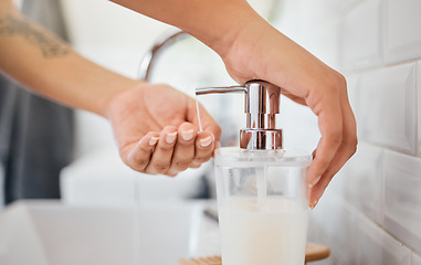 Image showing Hand washing, hygiene and soap dispenser with woman in bathroom rinsing with water for corona virus, germs or bacteria prevention. Closeup hands for cleanliness, self care and clean habits for health