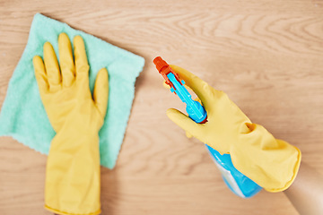 Image showing Cleaning spray, glove hands and wipe table, counter and wood surface for housekeeping service at home. Above of maid, janitor and cleaner dust cloth chore, furniture shine and chemical bottle product