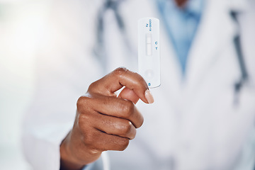 Image showing Doctor hands, covid and negative rapid antigen test results in hospital for healthcare, medical risk and safety. Closeup corona virus surgeon, medicine worker and clinic expert holding pcr cassette