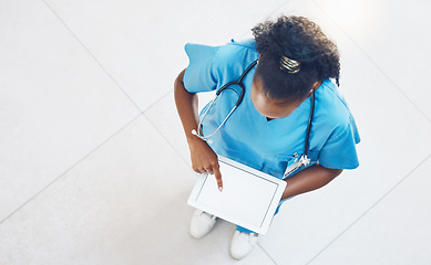 Image showing Doctor, tablet and healthcare website with blank mockup screen while standing and working in a hospital from above. Medical insurance app, nurse and 5g network for innovation in health and medicine