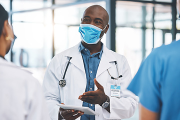 Image showing Covid, healthcare and teamwork with a doctor talking to his team about medicine in the hospital. Research, collaboration and communication with a surgeon working on a tablet in a clinic for health