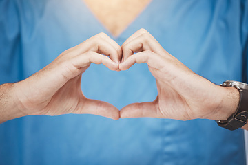 Image showing Doctor or nurse make heart sign, with hands to show care or compassion. Woman worker in healthcare show love icon with fingers, as expression of love for their job or wellness of patients