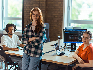 Image showing A diverse group of young business individuals congregates in a modern startup coworking center, embodying collaborative innovation and a dynamic atmosphere