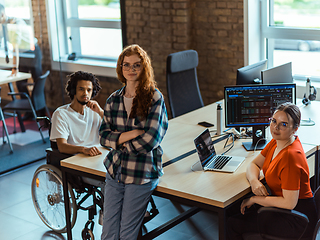 Image showing A diverse group of young business individuals congregates in a modern startup coworking center, embodying collaborative innovation and a dynamic atmosphere