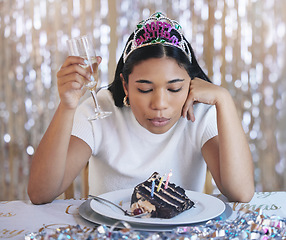 Image showing Sad woman birthday cake, celebrate home alone with champagne and sad at lonely pandemic party celebration. Young latino girl fail to blow candle on table, wish thinking and shiny crown decoration