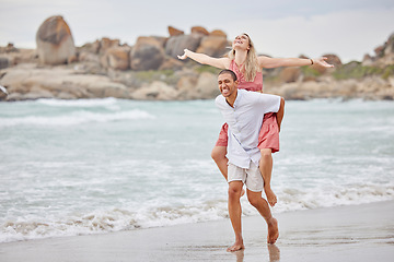 Image showing Beach, love and smile, an interracial couple at the sea during summer vacation. A happy man and woman laugh and a romantic date at the ocean. Waves, sand and romance, summer holiday the African sun.