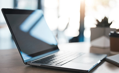 Image showing Laptop on a desk in modern office to work on a project, virtual business meeting or online research. Closeup of a computer, technology and pc on a table in the minimal company building.