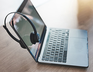 Image showing Laptop, headphones and call center telemarketing background on desk in office for contact us, video call and virtual online consulting. Zoom of customer support technology for internet communication