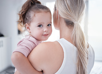 Image showing Family, love and care between mother and daughter bonding and spending free time together during day at home. Portrait of cute girl child with a woman, nanny or mom carrying her toddler