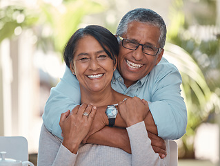 Image showing Portrait, elderly and couple bonding on a patio at home, hug, laugh and relax outdoors together. Love, retirement and happy seniors enjoying their relationship and bond, free time and fresh air