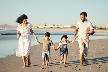 Image showing Happy family, beach and family bonding while walking and laughing at sunset, cheerful and relaxed. Fun parents sharing playful activity with their children, enjoying parenthood and walk along ocean