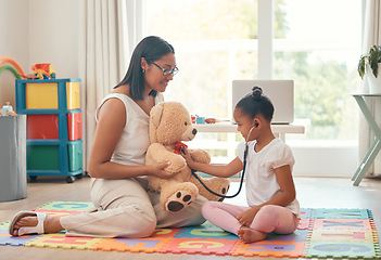 Image showing Kindergarten, education and stethoscope with teacher and girl playing doctor game with teddy bear for development, learning and care. Classroom, wellness and therapist with young student and woman