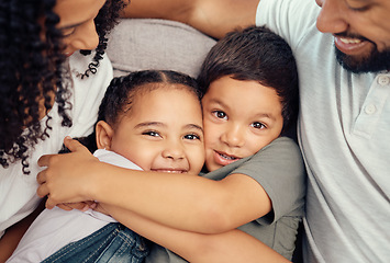 Image showing Portrait, happy family and children hug and bonding on a sofa, happy and relax with mother and father at home. Smile, relax and embracing kids enjoying a playful day with loving, caring parents