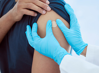 Image showing Band aid, hands and vaccine injection for covid, flu or global virus in security, safety or wellness insurance hospital. Zoom on doctor, medical employee or healthcare worker with arm plaster for man