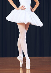 Image showing Ballet woman dancer on theatre stage for a dance performance or training for a professional art career. Artistic academy, ballerina girl with elegant legs and feet dancing in a creative opera show