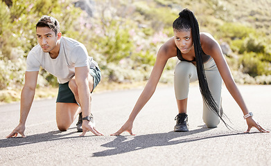 Image showing Sports race, fitness couple and ready to run asphalt road with competitive, fit and active runners for outdoor workout. Asian man and black woman sitting in position to start sprint, athlete training