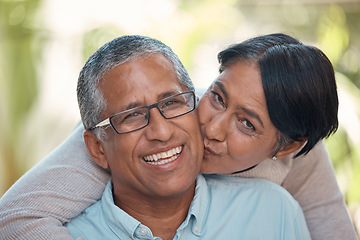 Image showing Love, kiss and happy senior couple sharing commitment, hug and affection while sitting together showing smile. Portrait of elderly indian man and woman enjoying retirement and free time to bond