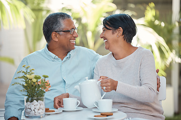 Image showing Mature couple laughing, drinking tea and bonding in backyard together, relax and cheerful outdoors. Senior man and woman enjoying retirement and their relationship,sharing a joke and tea time snack