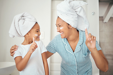 Image showing Mother, child and skincare face cream cosmetics in bathroom at home after shower, cleaning and hygiene. Happy mom, smile girl kid and healthy wellness with moisturizer, beauty lotion and body rub