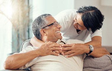 Image showing Love, senior couple and hug while laughing, bonding and sharing a romantic moment during retirement on the sofa at home. Joy, commitment and healthy relationship of an elderly man and woman together