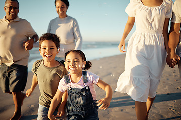 Image showing Happy family, beach vacation and children running during fun active activity in summer with parents and grandparents. Laughing, bonding and chasing joy while men, women and kids playing on holiday