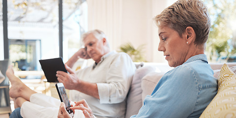 Image showing Relax senior couple on sofa with smartphone and tablet technology to watch film while networking on social media with home wifi. Elderly woman and man on couch with digital or online internet content