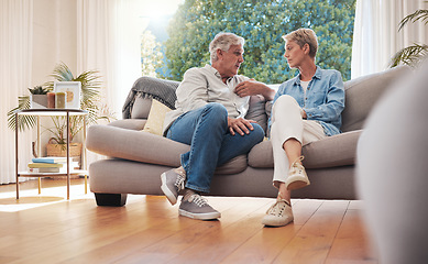 Image showing Senior couple, serious talk and communication about problems and marriage issues while sitting on the sofa at home. Mature man and woman talking and discussing issues, trouble and divorce