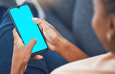 Image showing Black woman, hands and phone with green screen mockup for marketing, branding and advertising. African female hand on mobile technology with blank display for social media, texting and message or app