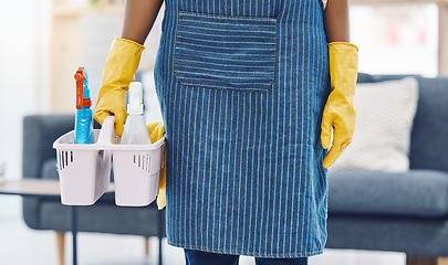 Image showing Cleaning service, product basket and cleaner for maid advertising or marketing in living room apartment, home or house. Woman housekeeping worker hands with spray bottle and liquid detergent in house