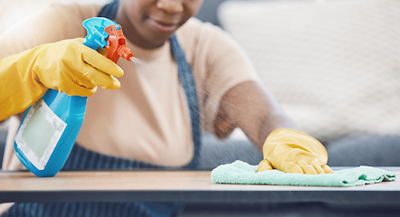 Image showing Woman with detergent to clean, spray and wipe table, in office or living room in home. Black woman in domestic work, use cloth and liquid cleaner, on desk for hygiene in lounge of business or house