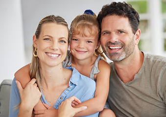 Image showing Family, mom and dad with child in their home, sitting and posing in the living room. Portrait of happy, loving and smiling mother, father and daughter together. Happiness and love in family home