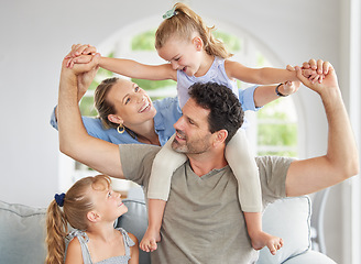 Image showing Happy family, play and bonding on a sofa in their home, cheerful and having fun. Young parents being playful and loving with their girls, enjoying a game on the weekend with fun mother and father