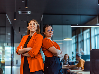 Image showing Group of determined businesswomen confidently pose side by side in a modern startup coworking center, embodying professionalism and empowerment