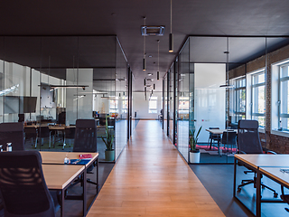 Image showing In a setting of modern, glass-walled business startup offices, the open, airy workspace reflects a contemporary and innovative ambiance, promising a dynamic environment for entrepreneurial growth