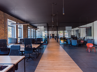 Image showing In a setting of modern, glass-walled business startup offices, the open, airy workspace reflects a contemporary and innovative ambiance, promising a dynamic environment for entrepreneurial growth