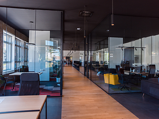 Image showing In a setting of modern, glass-walled business startup offices, the open, airy workspace reflects a contemporary and innovative ambiance, promising a dynamic environment for entrepreneurial growth